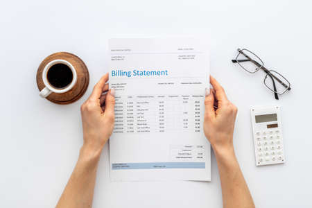 Hands holding medical billing statement. Payment for health care serviceの写真素材