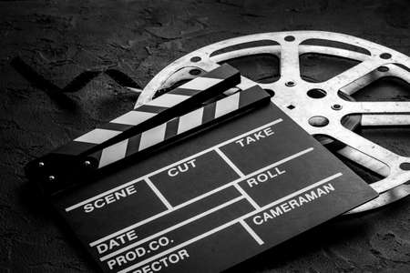 Movie clapper with film reel. Cinema backgroundの写真素材