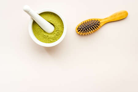 Henna hair dye powder and wooden comb. Henna in wtite mortarの写真素材