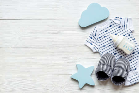 Flat lay of baby boy bodysuit with malk bottle. Baby backgroundの写真素材