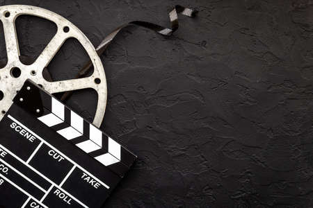 Movie film reel with clapperboard. Cinema conceptの写真素材
