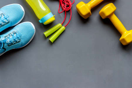 Flat lay of fitness gym equipment with sneakers and bottle of waterの写真素材