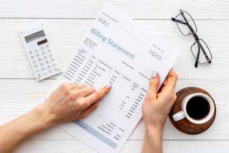 Hands holding medical billing statement. Payment for health care serviceの写真素材