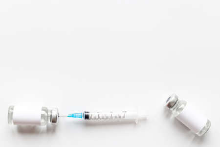 Vaccination with vaccine in bottles with syringeの写真素材