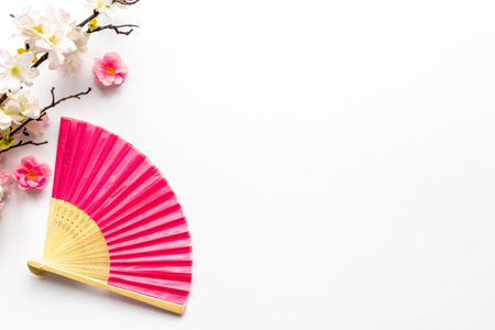 Japanese hand fan with cherry blossom branch. Top viewの写真素材