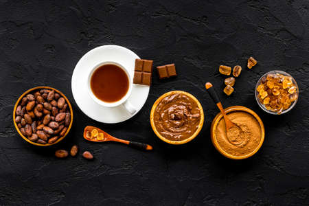 Hot chocolate in cup with cocoa and coffee beans, top viewの写真素材