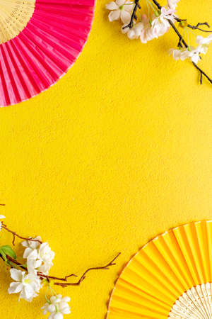 Blossom branches with Asian hand fans. Top viewの写真素材