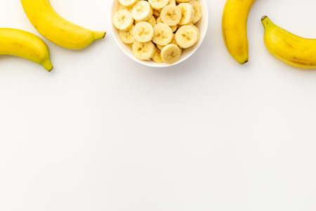 Banana slices in bowl. Fresh friuts top viewの写真素材