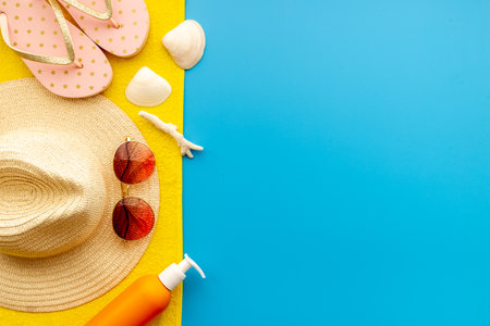 Summer holiday background with beach hat and flip flops. Top viewの写真素材