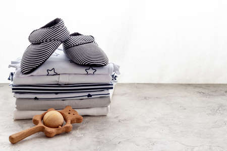 Stack of baby clothers and shoes. Set of baby accessories, close up