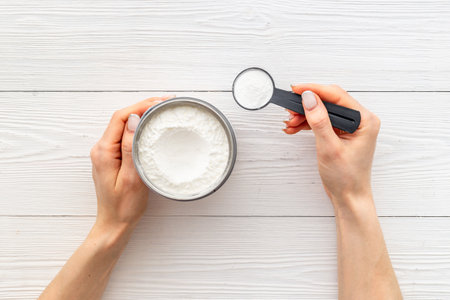 Hands holding protein powder in scoop. Sport nutritionの写真素材