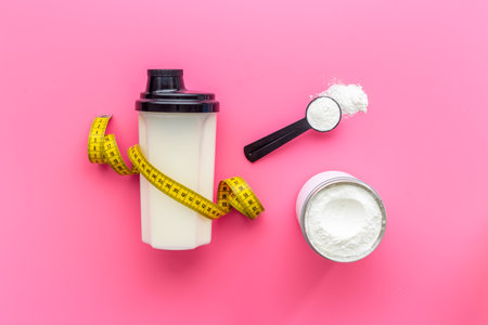 Sport nutrition - whey protein powder with tape measure. Top viewの写真素材