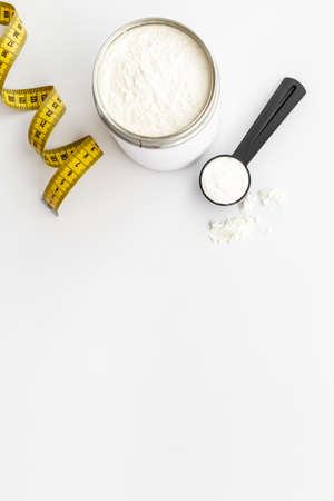 Whey prorein in jar with tape measure. Sport nutrition. Overhead viewの写真素材