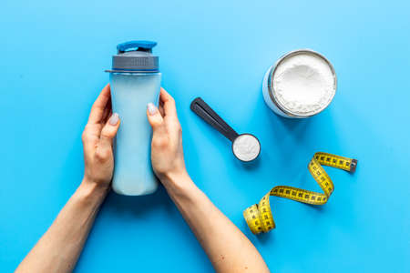 Hands holding shaker with protein smoothie. Sport nutritionの写真素材