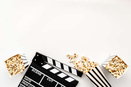 Layout of film reel with popcorn and clapperboard. Cinema conceptの写真素材
