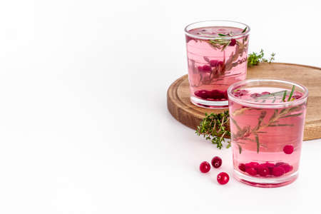 Glasses of cold drink with cranberry and rosemaryの写真素材
