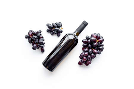 Red wine bottle isolated with grapes. Top viewの写真素材