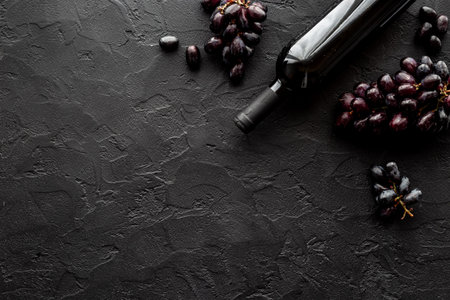 Bottle of red wine and dark grape. Top viewの写真素材