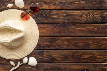 Top view of summer beach accessories. Sraw hat with sunglasses and flip flopsの写真素材