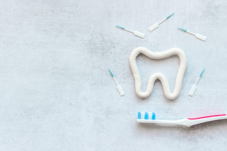 Flat lay of toothbrush with toothpaste, oral care products