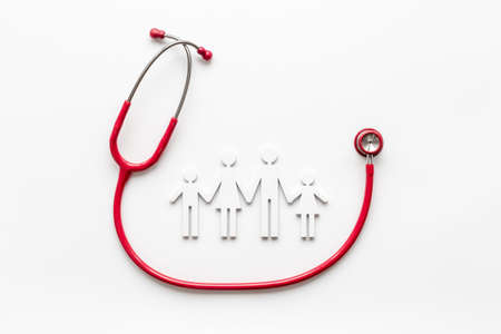 Medical care concept. Family figure with stethoscope, top viewの写真素材