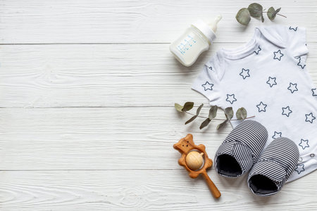Flat lay of baby boy bodysuit with milk bottle.の写真素材
