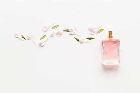 Top view of perfume bottle with flowers and leavesの写真素材