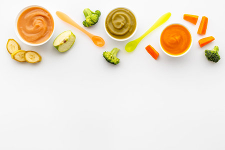 Baby fruit vegetables food - mousse in bowls with fresh vegetables and fruits