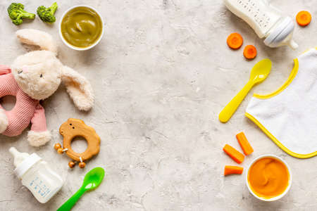 Baby accessories for feeding with fruits food milk bottle and toysの写真素材