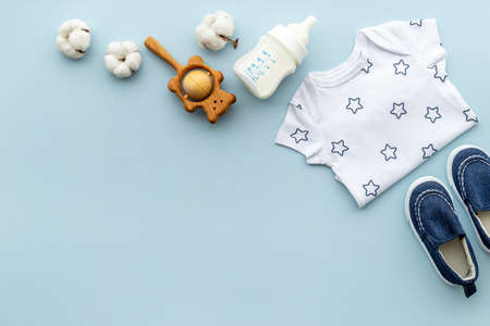 Flat lay of baby boy bodysuit with malk bottle. Baby backgroundの写真素材