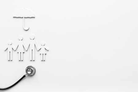 Family figure with stethoscope, health care and family doctor conceptの写真素材