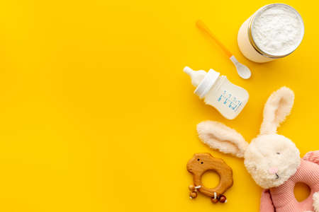 Baby milk in bottle with toy and powdered milkの写真素材