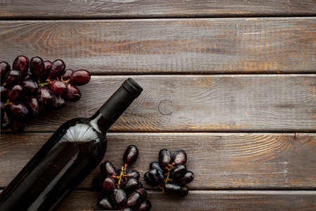 Top view of red wine bottle with grapeの写真素材