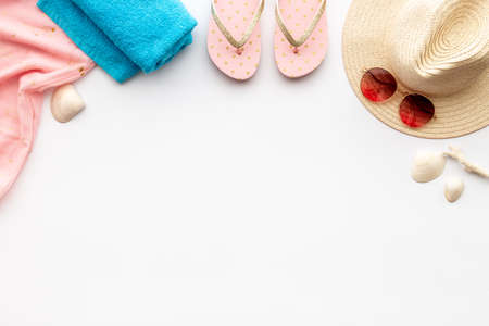 Beach accessories isolated on white. Hat with sunglasses and flip flops. Overhead viewの写真素材