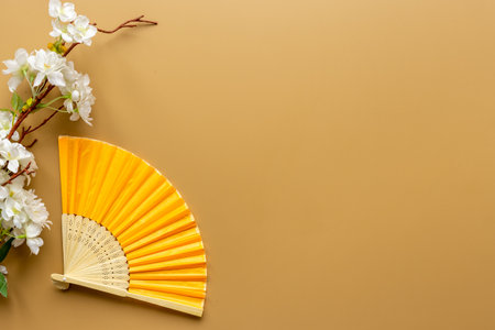 Yellow golden hand fan made of bamboo and paper. Top viewの写真素材