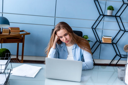 Tired owerworked blonde woman at the office with computer