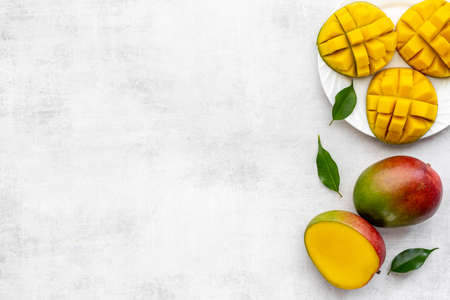 Plate of mango fruits and mango cubes. Tropical breakfast. Top viewの写真素材