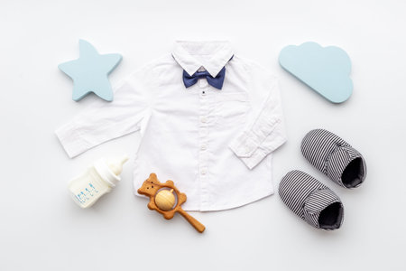Bodysuit shirt and shoes for baby boy. Baby flat lay background