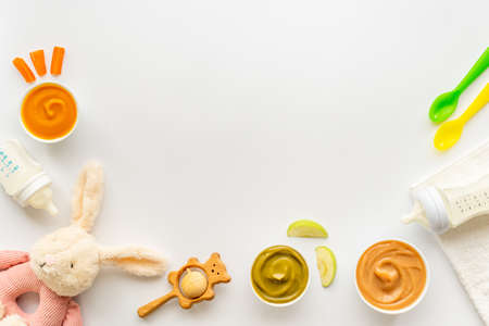 Baby accessories for feeding with fruits food milk bottle and toysの写真素材