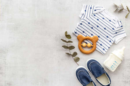 Flat lay of baby boy bodysuit with malk bottle. Baby backgroundの写真素材