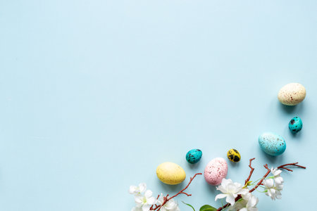 Easter eggs and spring flowers, top view