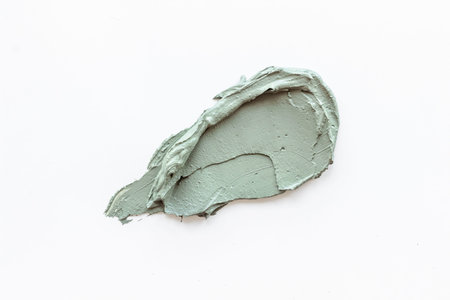 Cosmetic blue clay mask isolated on white background