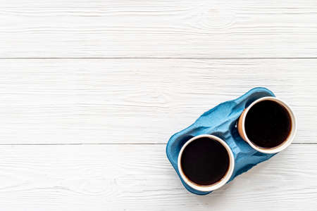 Top view of black coffee in paper cupsの写真素材