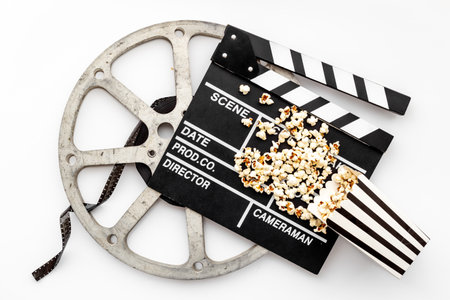 Movie film reel with clapperboard and popcorn. Cinema conceptの写真素材