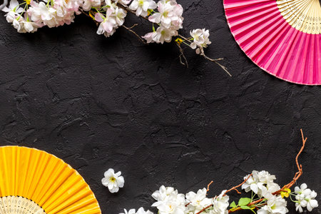 Blossom branches with asian hand fans. Top view