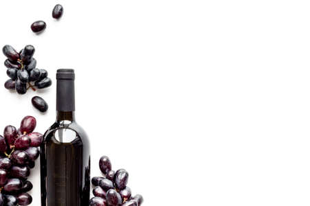 Bottle of red wine isolated and dark grape. Top viewの写真素材