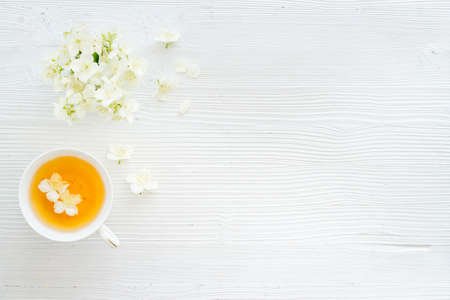 Tea in a cup with jasmine flowers. Herbal tea top viewの写真素材