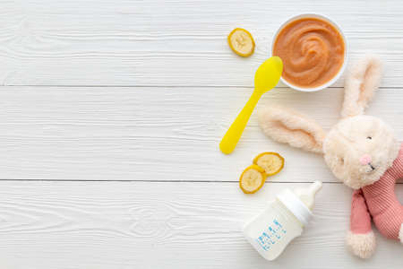 Fresh baby fruit food puree and milk bottle. Top viewの写真素材