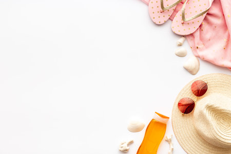 Layout of beach accessories with sun cosmetics, sunglasses and flip flops