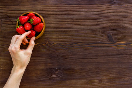 Bowl of ripe strawberry with leaves. Berry flay lay, top viewの写真素材